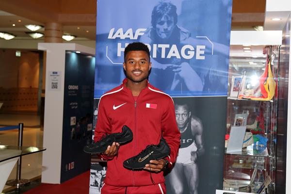 Owaab Barrow accepts Allen Johnson's spikes from the 1997 World Championships (IAAF)