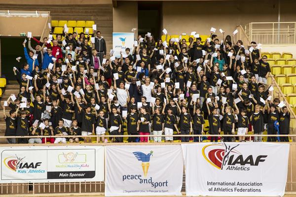 Schoolchildren in Monaco hold up their white cards to mark the first ever International Day of Sport for Development and Peace (Philippe Fitte)
