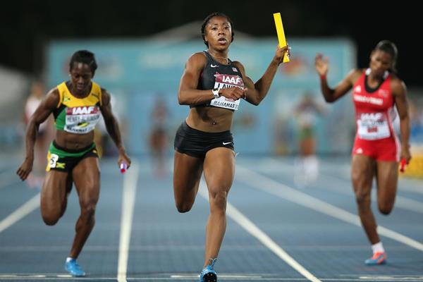 LaKeisha Lawson of the United States crosses the finish line ahead of Samantha Henry-Robinson (L) of Jamaica and Kai Selvon (R) of Trinidad and Tobago to win the Women's 4x100 metres relay during day one of the IAAF World Relays (Getty Images)