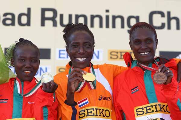 Lornah Kiplagat of the Netherlands celebrates her world record and victory in the women's race with silver medalist Mary Jepkosgei Keitany of Kenya and bronze medalist Pamela Chepchumba of Kenya (Getty Images)