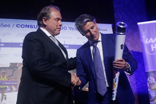 Sebastian Coe is presented with the Youth Olympic Games torch at ConSudAtle's centenary (IAAF)