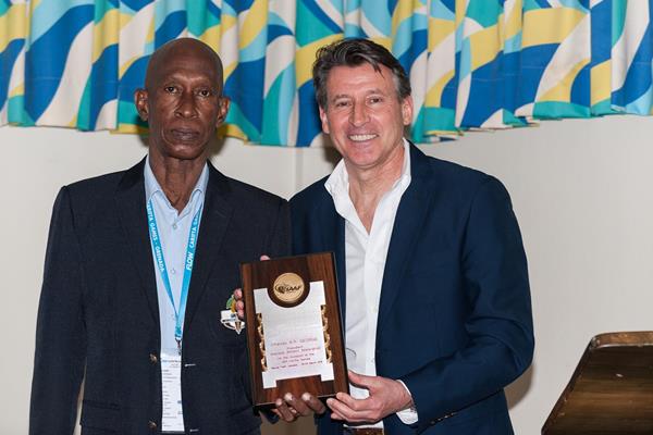 IAAF President Coe presenting a commemorative plaque to the President of the Grenada Athletics Federation Charles George (CARIFTA)