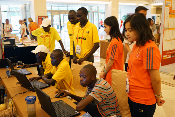 Members of the Ugandan team visit the IAAF's outreach stand in Beijing (IAAF)