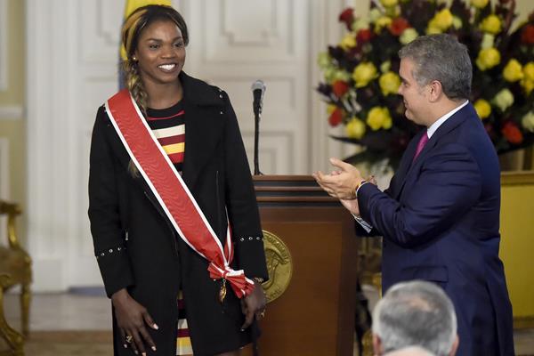 Caterine Ibarguen receives the Grand Cross of the National Order of Merit from Colombian President Ivan Duque (AFP/Getty Images)