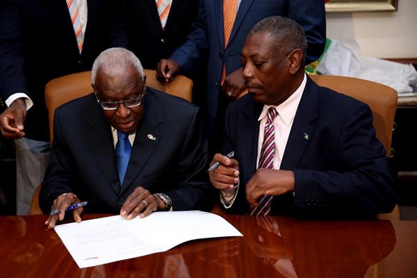 President Diack signs the document foir The Bahamas to be the host of the 2017 IAAF World Relays (Getty Images)