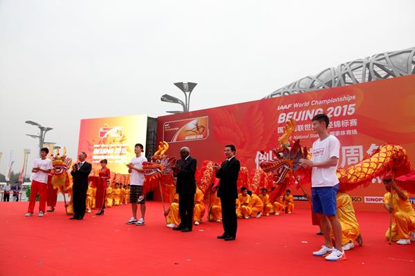 Dignatories and Chinese athletes at the 'One Year To Go' ceremony for the IAAF World Championships, Beijing 2015, including Liu Xiang and IAAF President Lamine Diack (centre) (IAAF / LOC)