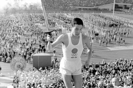 Yoshinori Sakai about to light the flame at the 1964 Olympic Games (Getty Images)
