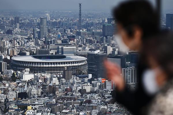 People look out at Tokyo's Olympic Stadium (AFP / Getty Images)