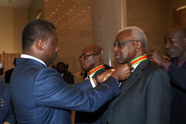 Togo President Faure Essozimna Gnassingbe presents the Commander of the Order of Mono award to President Diack (IAAF)