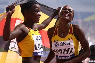 Halimah Nakaayi and Winnie Nanyondo celebrate after the women's 800m final in Doha (AFP/Getty Images)