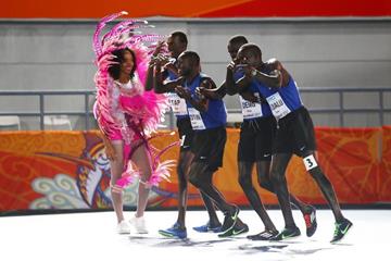 Members of the Athlete Refugee Team celebrate with a local dancer in Nassau (Getty Images)