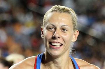 Tatyana Chernova of Russia celebrates with her country's flag after claiming gold in the women's heptathlon during day four (Getty Images)