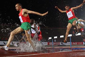 Moroccan 3000m Steeplechase gold medallist Abulqader el-Hashlaf (L) powers through the water with Moroccan silver medal winner Hamid el-Zein (R) at the 11th Pan Arab Games in Cairo, 23 November 2007 (AFP / Getty Images)