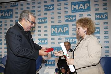 Jamila Benchrif receives the Wissam Royal de l'Ordre de Mérite National de la Première Catégorie award on behalf of her husband Mohamed Benchrif ()