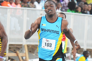Javan Martin of The Bahamas on his way to winning the 100m at the Carifta Games (Collin Reid)