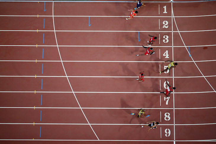 Sprinters crossing the line in the men's 100m final in Beijing ()