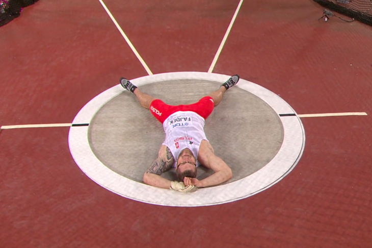 Pawel Fajdek lies in the hammer circle after winning gold (IAAF live feed)